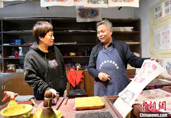 10月28日，国家级非物质文化遗产武强木版年画代表性传承人马习钦在和徒弟交流印刷技艺。　苏小立 摄