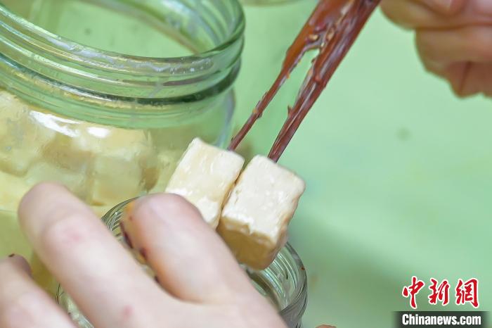 员工把做好的腐乳装进瓶内。　陈永诺 摄
