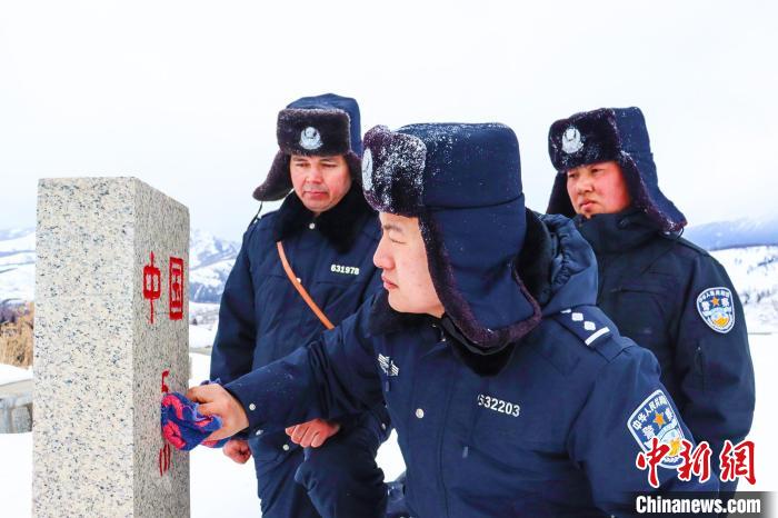 民警擦拭界碑。　李铭骥 摄