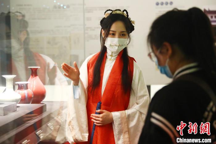 5月17日，江西省博物馆讲解员徐晨颖(左)身穿汉服为观众讲解景德镇瓷器等文物。　刘占昆 摄