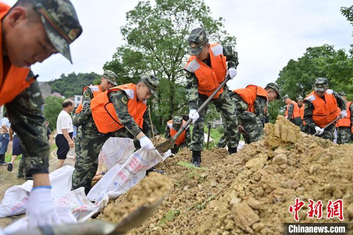 武警江西总队机动支队官兵奔赴江西景德镇市乐平市开展抢险救援，填装沙袋。　彭丁 摄