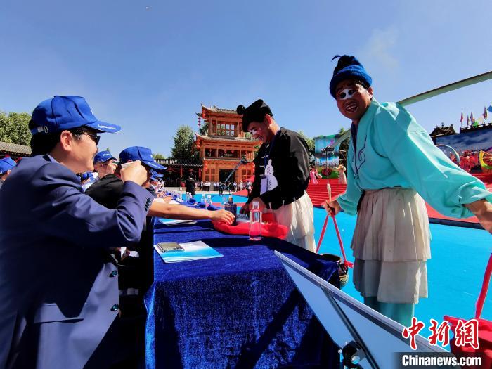 图为前来参加开幕式的观众品尝青稞酒。　祁增蓓 摄