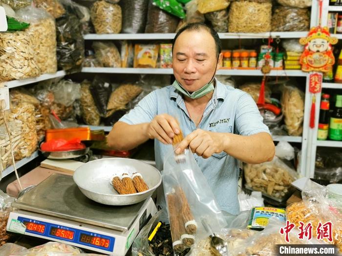 资料图为广东台山富城市场内，一药材档的老板为顾客用密实袋打包参丝。 <a target='_blank' href='/'>中新社</a>发 李晓春 摄