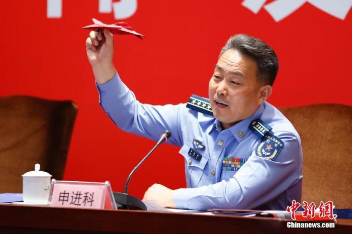 图为申进科大校在发布会上展示军迷赠送的折纸飞机。 <a target='_blank' href='/'>中新社</a>记者 富田 摄