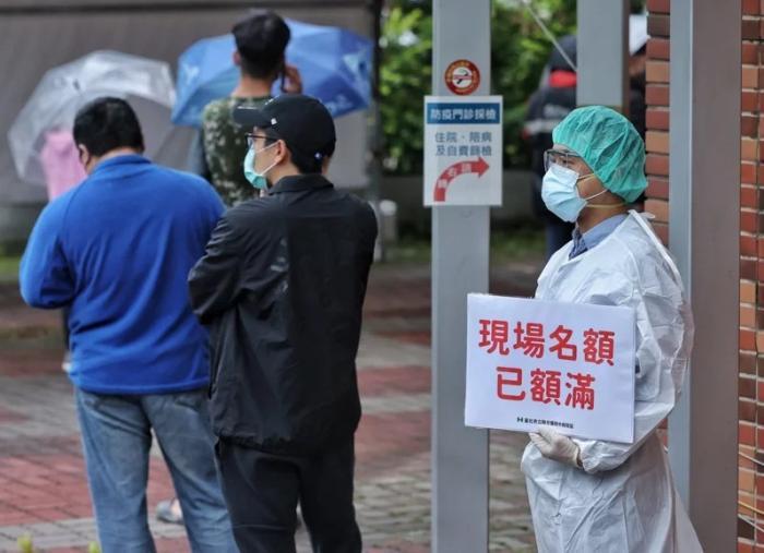 資料圖：台灣快篩站現場名額額滿，醫護人員于排隊末端舉牌提醒。圖片來源：台灣《聯合報》，記者 曾原信 攝