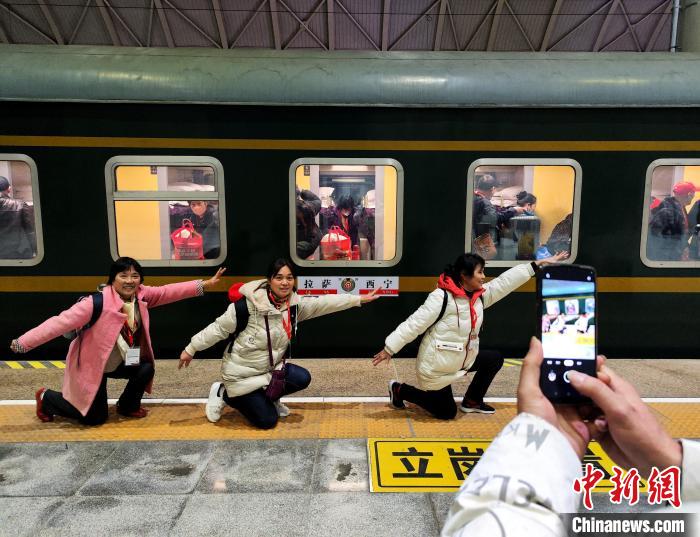 图为乘坐首趟进藏旅游专列的旅客与列车合影。　杨红健 摄