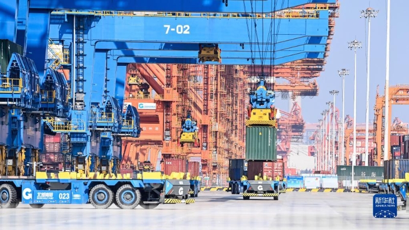 在广西钦州港自动化集装箱码头，无人驾驶车辆在转运集装箱。（图源：新华社）