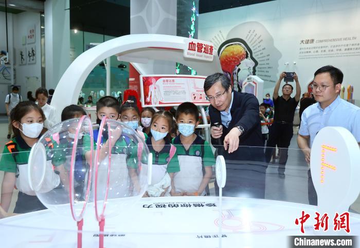 中国科技馆“共话健康真意”展厅内，专家指导青少年观众参观展品。　中国科技馆 供图