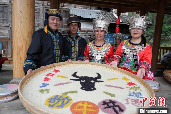 5月27日，在广西龙胜各族自治县马堤乡，当地苗族民众摆出牛头造型的五彩糯饭庆祝“敬牛节”。　韦吉阳 摄