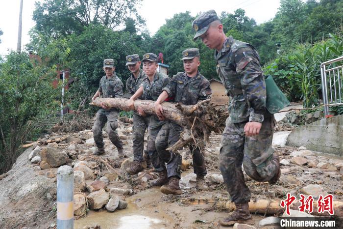 7月4日，万州区长滩镇，武警官兵清理受灾现场。　李东 摄