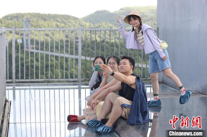 民众在景区“悬挑空中玻璃走廊”上自拍。　瞿宏伦 摄