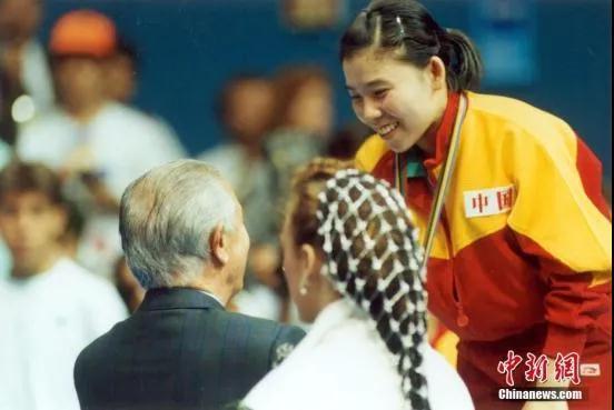 资料图：1992年8月5日，萨马兰奇向取得奥运乒乓球女子单打冠军的邓亚萍表示祝贺，并亲自为她颁奖。<a target='_blank' href='/'>中新社</a>记者 赵伟 摄