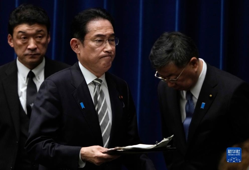 12月13日，日本首相岸田文雄（中）在日本东京首相官邸召开记者会后走过内阁官房长官松野博一（右）。（图源：新华社）